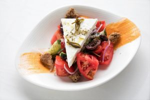 Greek salad in a white bowl
