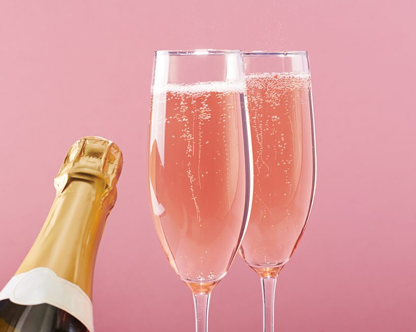 Two flutes of pink sparkling wine