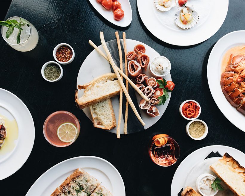Various Italian dishes on white plates