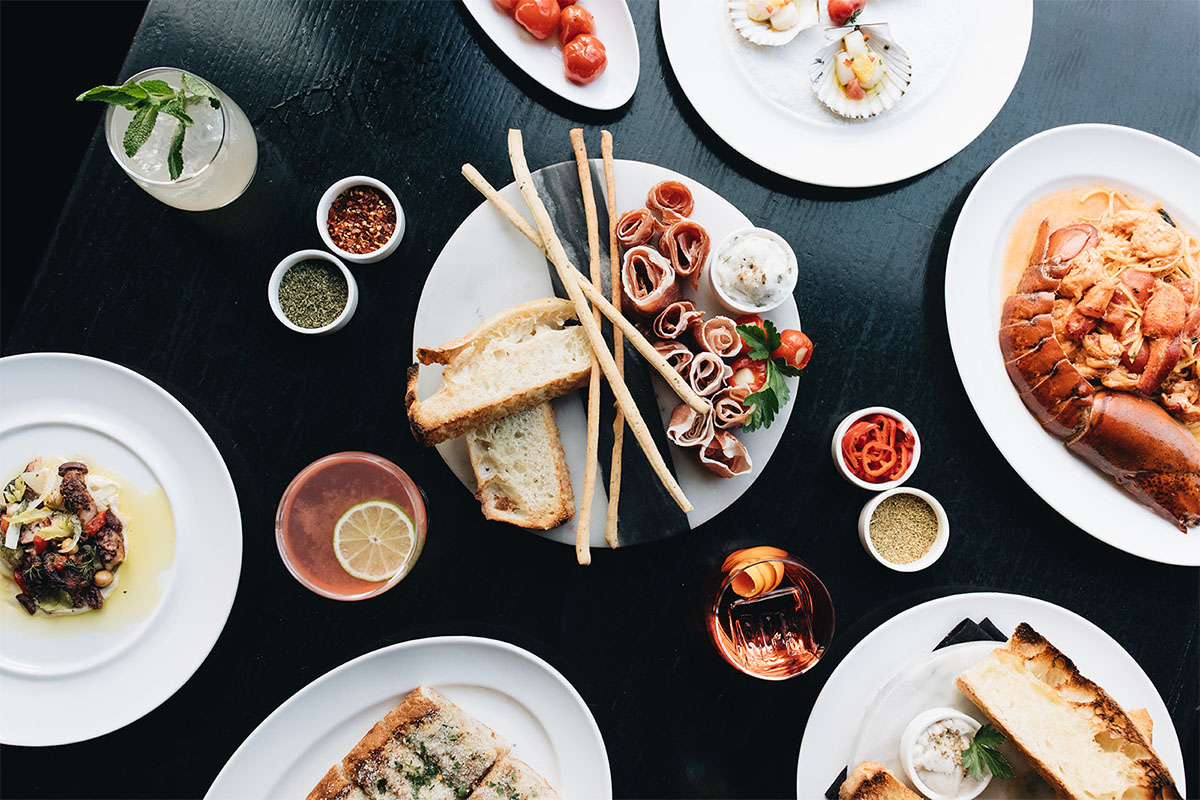 Various Italian dishes on white plates
