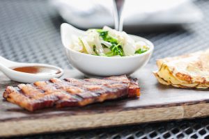 Bacon, pancakes, and more on a plate