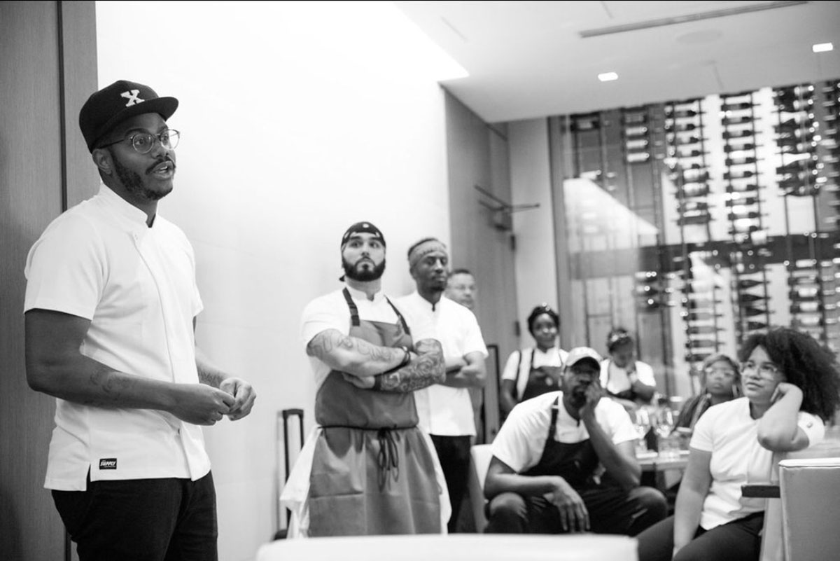 Kwame Onwuachi speaks to his staff