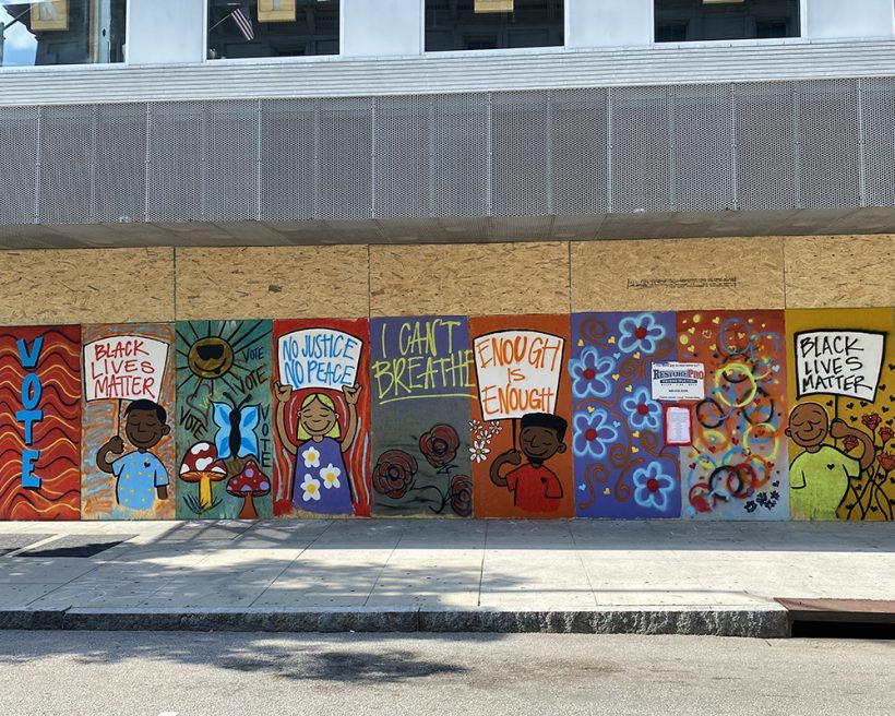 A Black Lives Matter mural on boarded-up restaurant windows