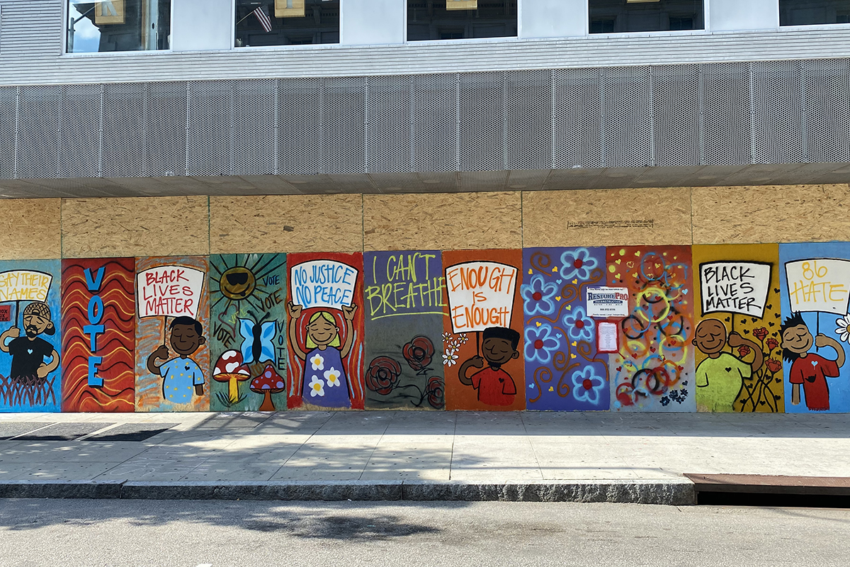 A Black Lives Matter mural on boarded-up restaurant windows