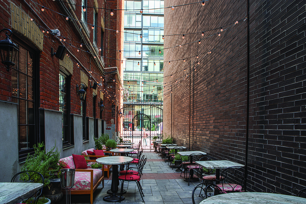 Tables in between two brick buildings