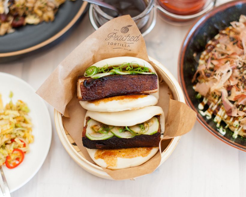 Two pork belly buns in a steam basket