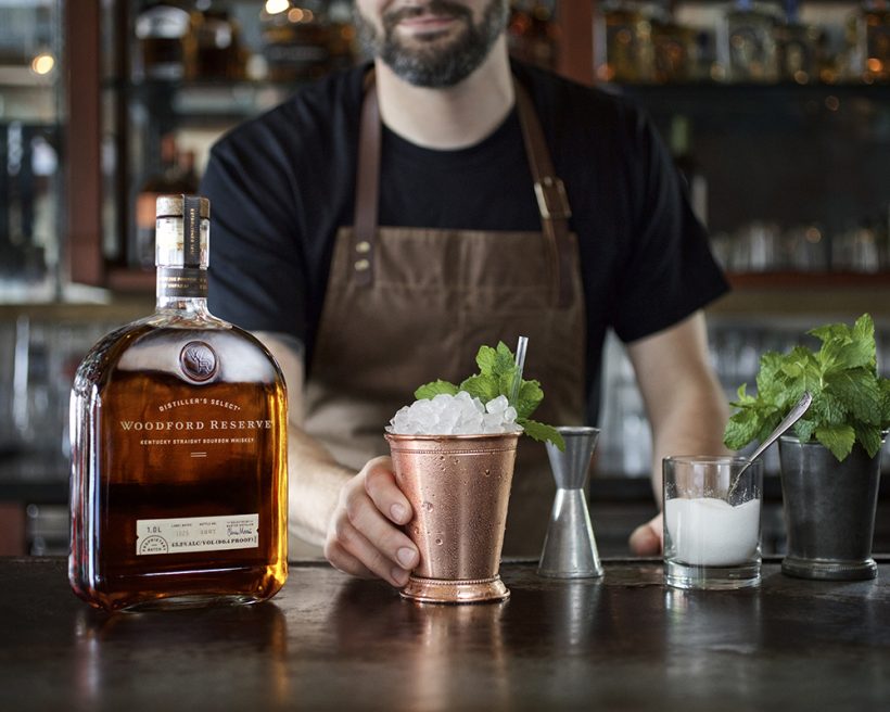 A bartender prepares a mint julep