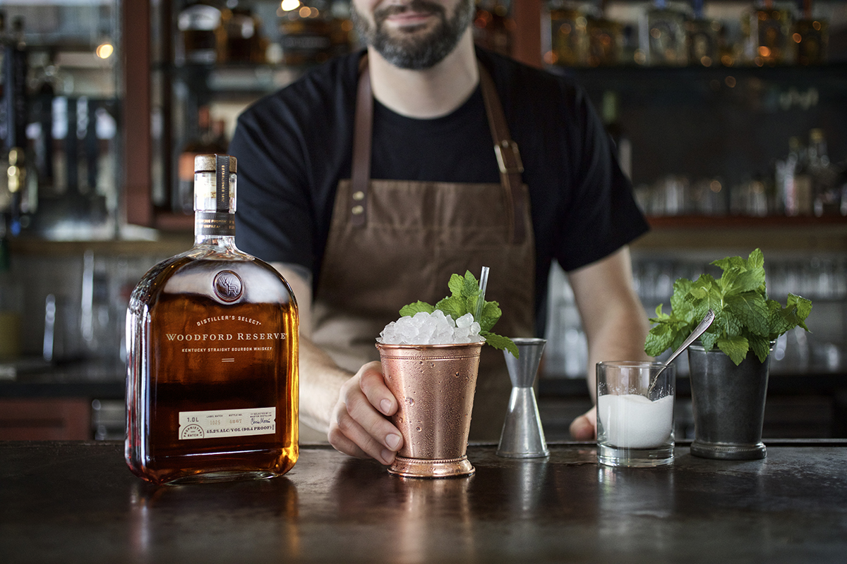 A bartender prepares a mint julep