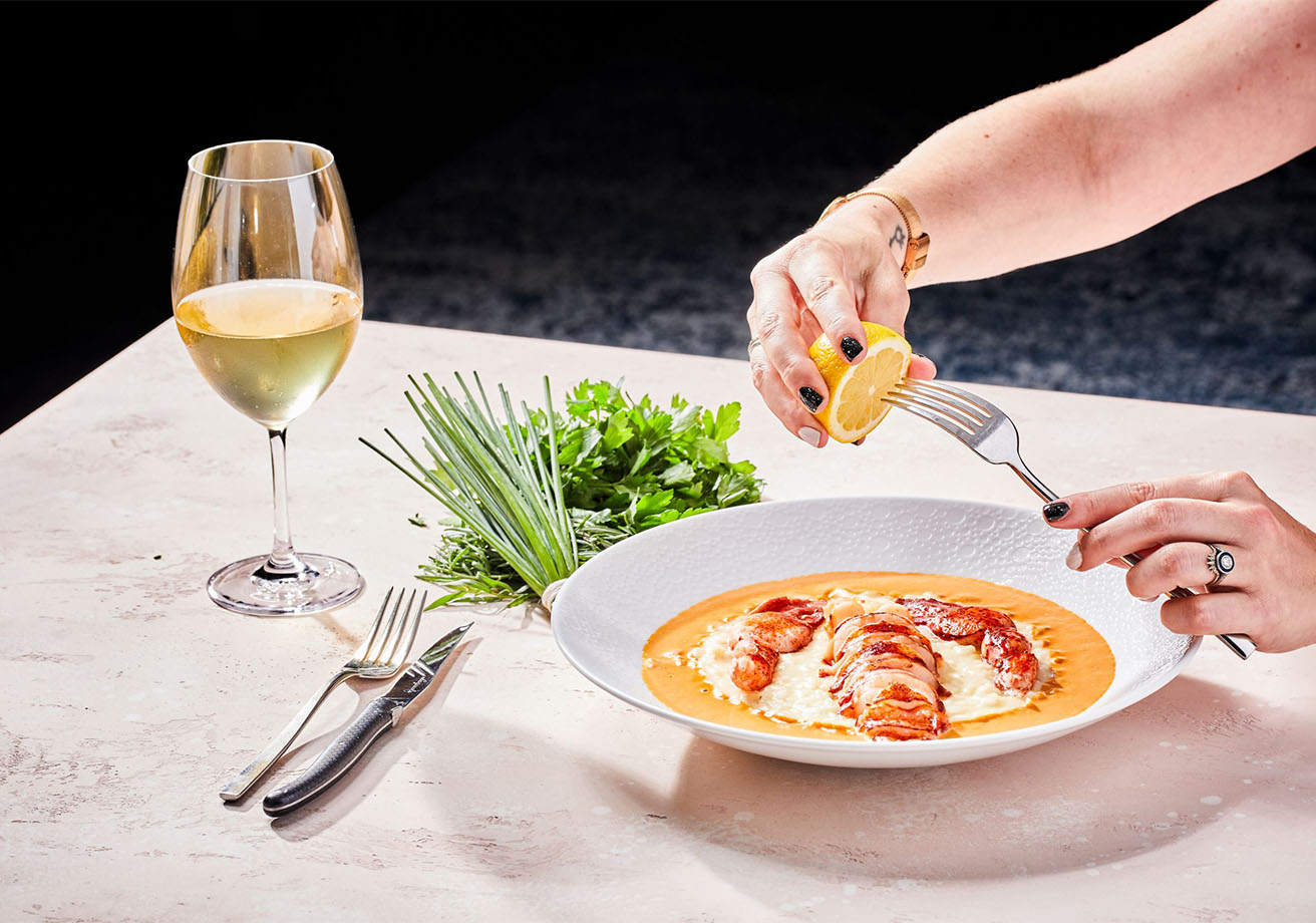 A plate of lobster and a glass of wine