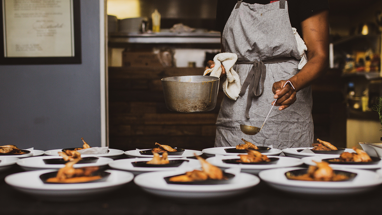 A Black chef preparing food
