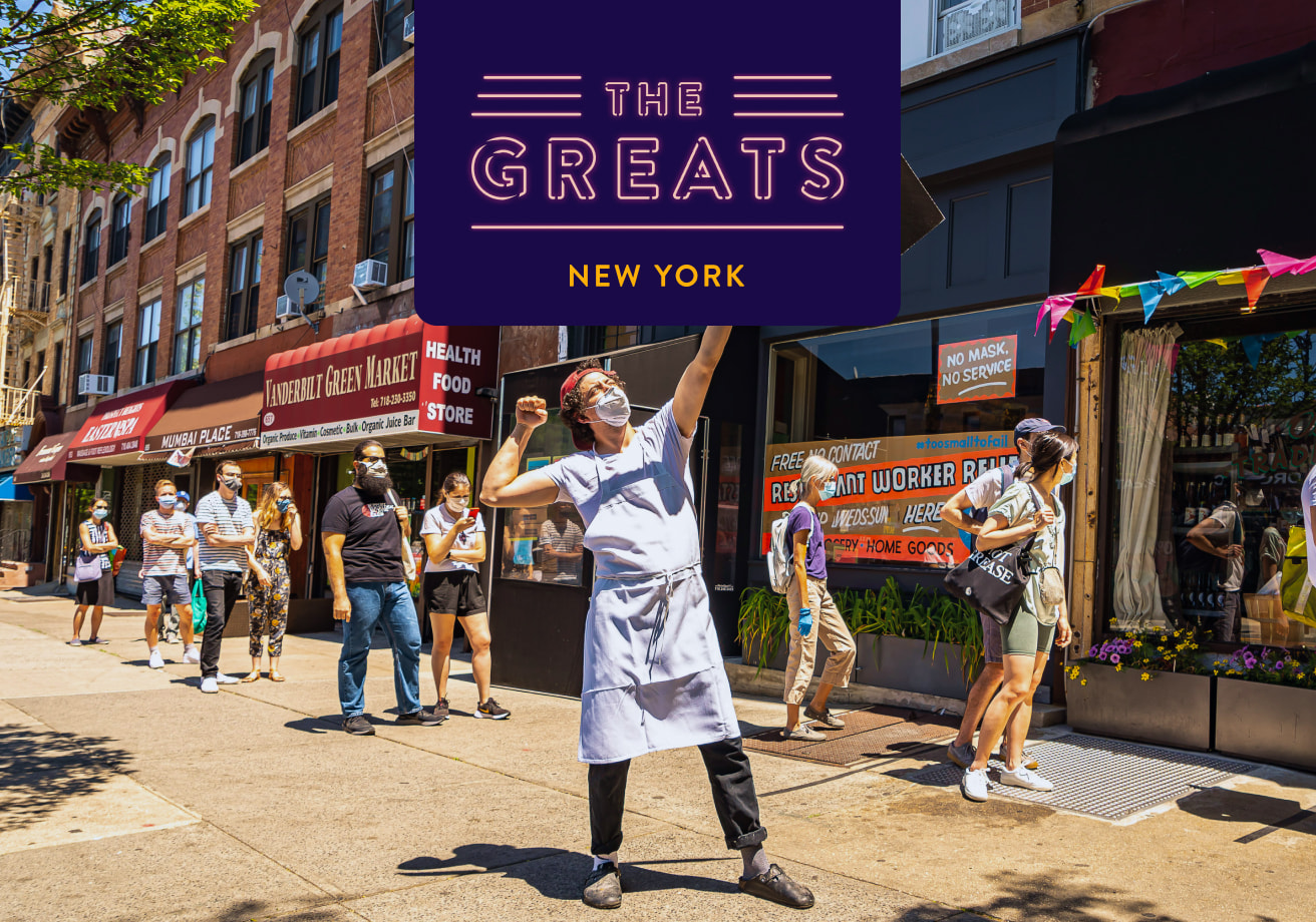 A restaurant worker stands in a powerful pose