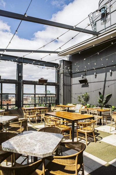 Bistro lights and plants make up the rooftop at Cabra in Chicago.