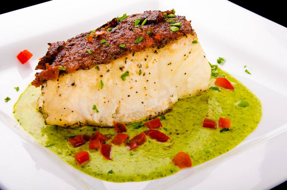 Pan-seared Chilean sea bass with sun-dried tomato pesto crust at Kenny’s Wood Fired Grill in Dallas
