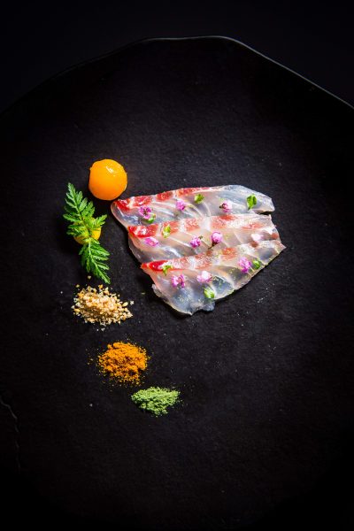 Sashimi adorned with flower petals at Providence in Los Angeles