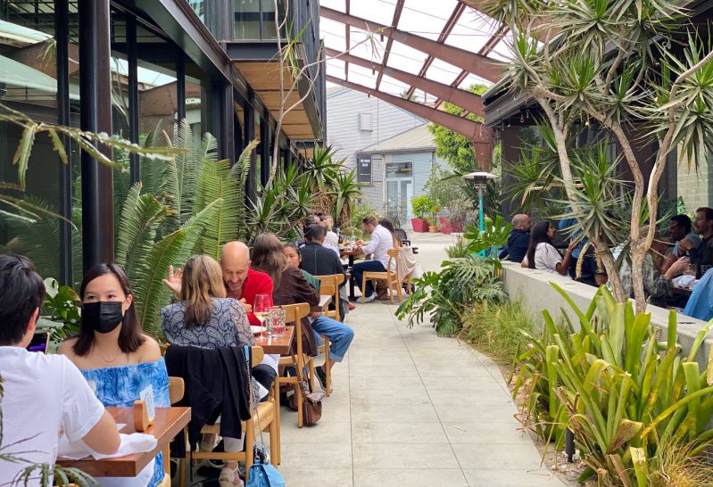 Guests dine outdoors on a covered patio