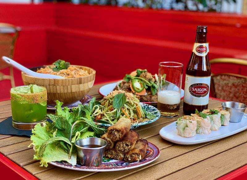 A spread of Vietnamese Cajun dishes on the patio at Phuc Yea in Miami