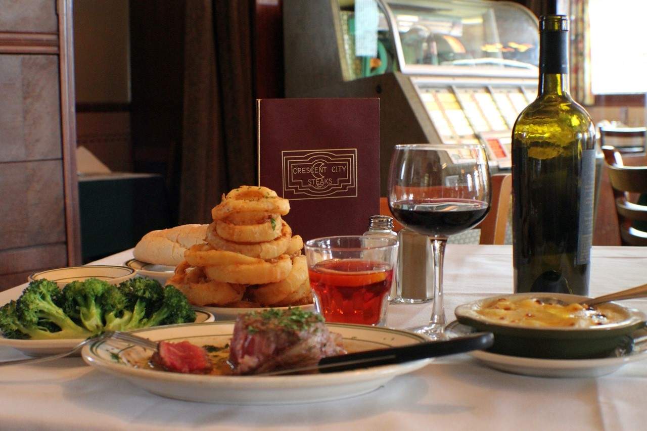 A steak with various sides at Crescent City Steaks in Mid-City