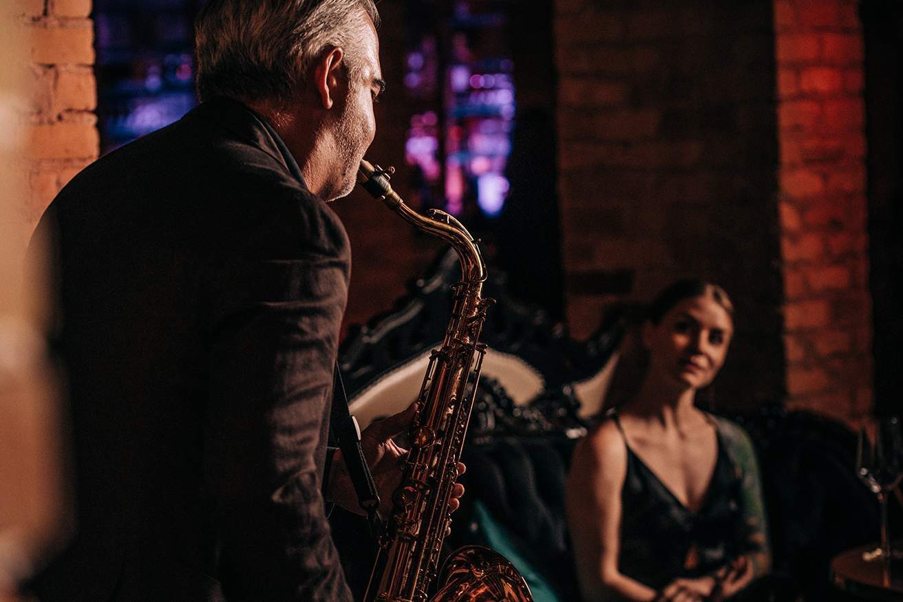 A saxophonist performs at Devil May Care in downtown Austin