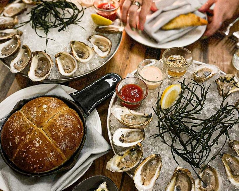 Two roasted oyster platters and freshly baked bread at Tempest in Charleston