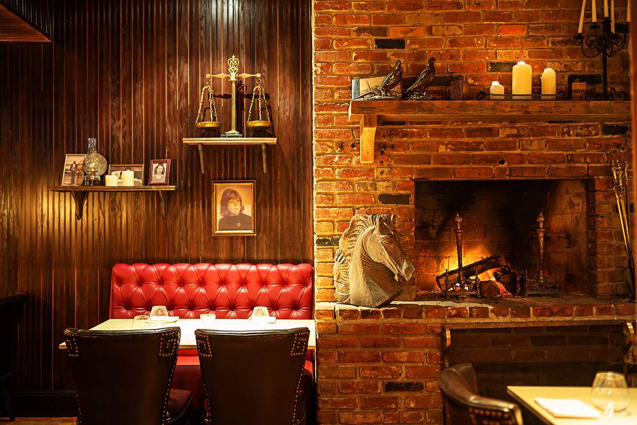 A fireplace and 19th-century inspired decor at Iron Gate in Dupont Circle