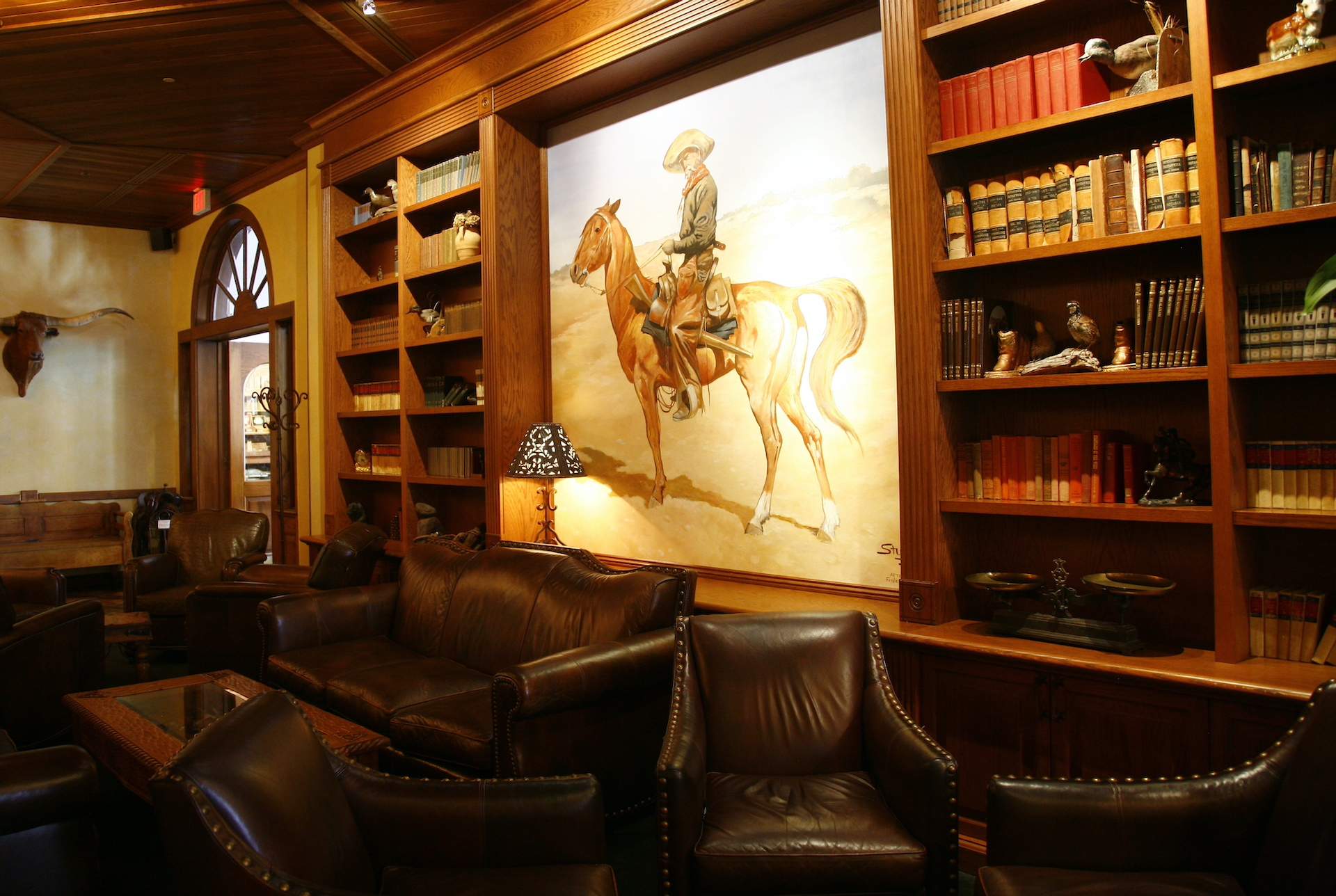 A painting of a cowboy on horseback at Reata in Fort Worth.