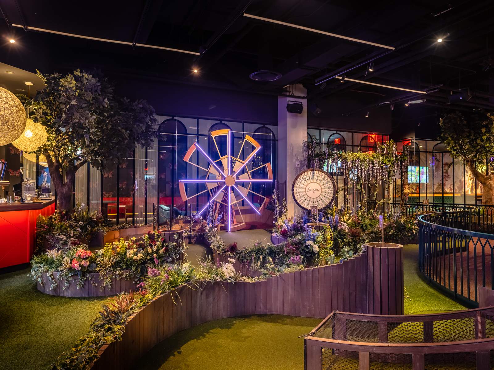 A mini-golf course decked with faux flowers at Swingers - NYC in NoMad