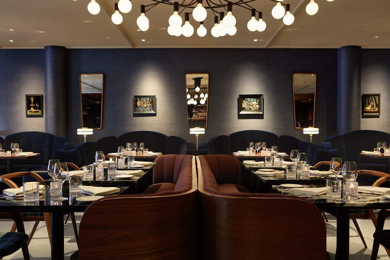 Leather, wood, and marble accents dress the dining area at The Betty in Buckhead