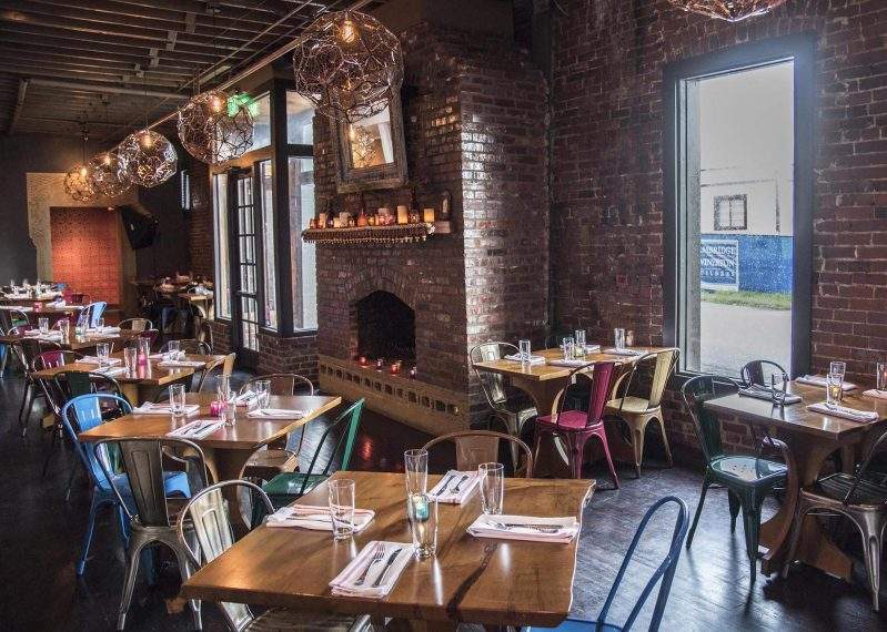 Exposed brick walls and colorful lights Chauhan Ale and Masala House in Nashville