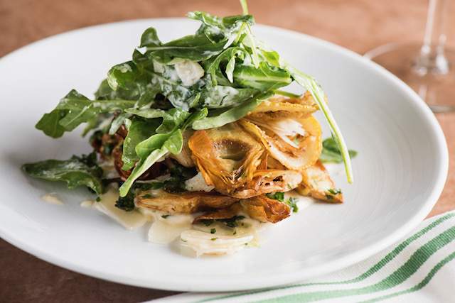 Crispy baby artichokes with shaved Parmesan, baby arugula, parsley, and lemon at Meadowsweet in New York City
