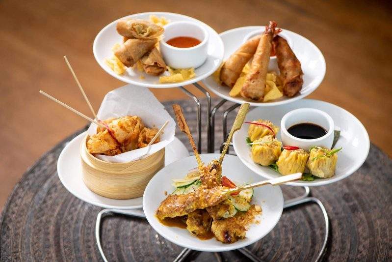 Appetizers at Nan Thai Fine Dining in Atlanta include grilled chicken breast tenders on bamboo skewers, rice paper rolls, crispy spring rolls, shrimp and chicken dumplings, crispy shrimp, and crispy calamari