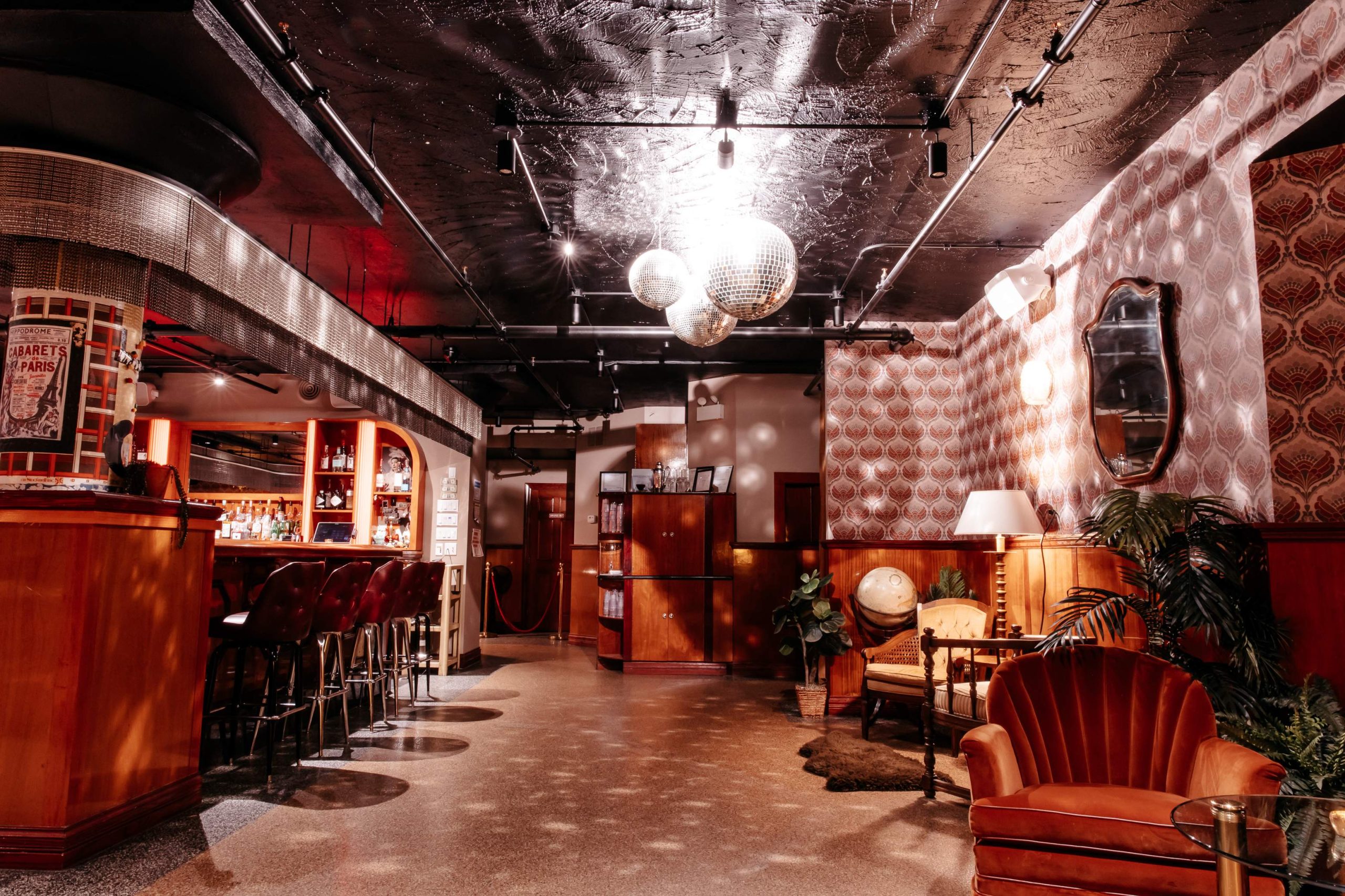A trio of disco balls dangle from the ceiling at Dorothy in Chicago