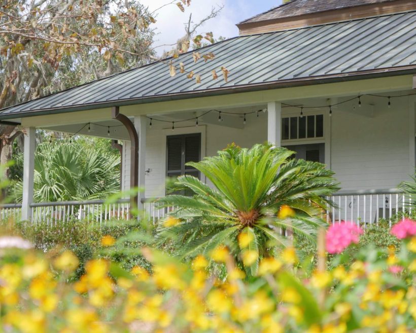 The patio Audubon Clubhouse Cafe in New Orleans is framed by historic oak trees and a lush garden.