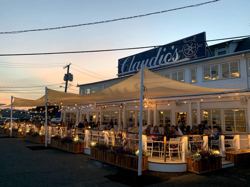 Diners feast on seafood at the partially covered veranda at Claudio’s Tavern and Grill in the Hamptons.