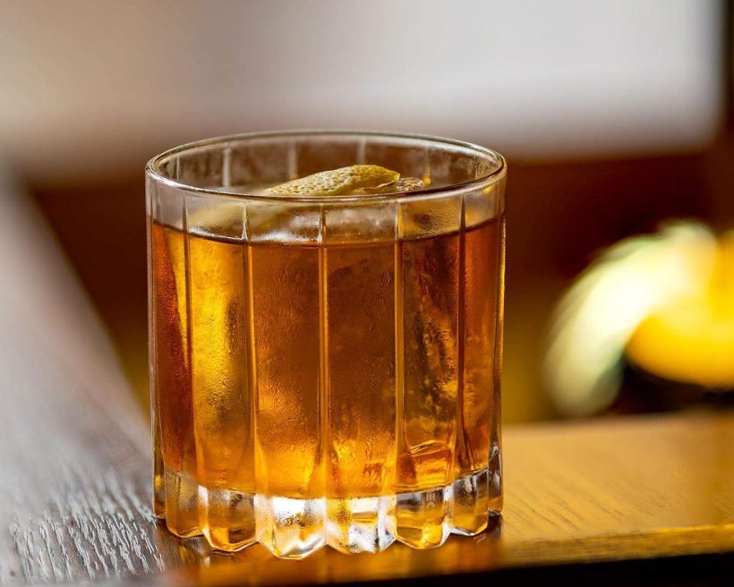 A Sometimes Old Fashioned cocktail at Cold Drinks Bar in San Francisco made with Peking duck fat-washed Scotch, rye, black pepper, mushroom, Angostura bitters, and lemon bitters