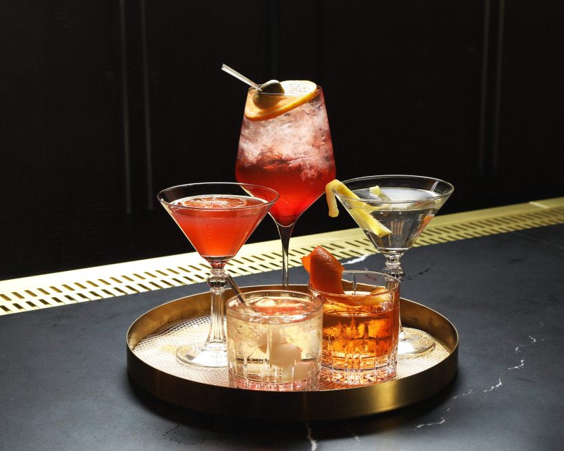 A round gold tray topped with five classic cocktails at Sinatra Bar and Lounge in Nashville