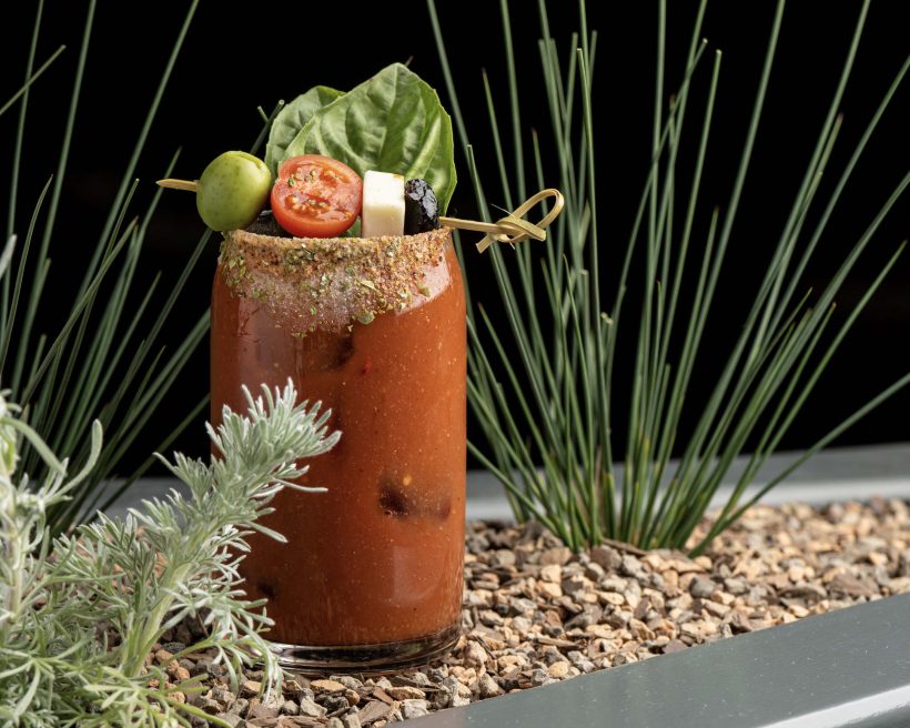 A bloody Mary at Superfine Playa in Los Angeles made with vodka, Superfine bloody mix, olives, basil, mozzarella, and snap pea salt
