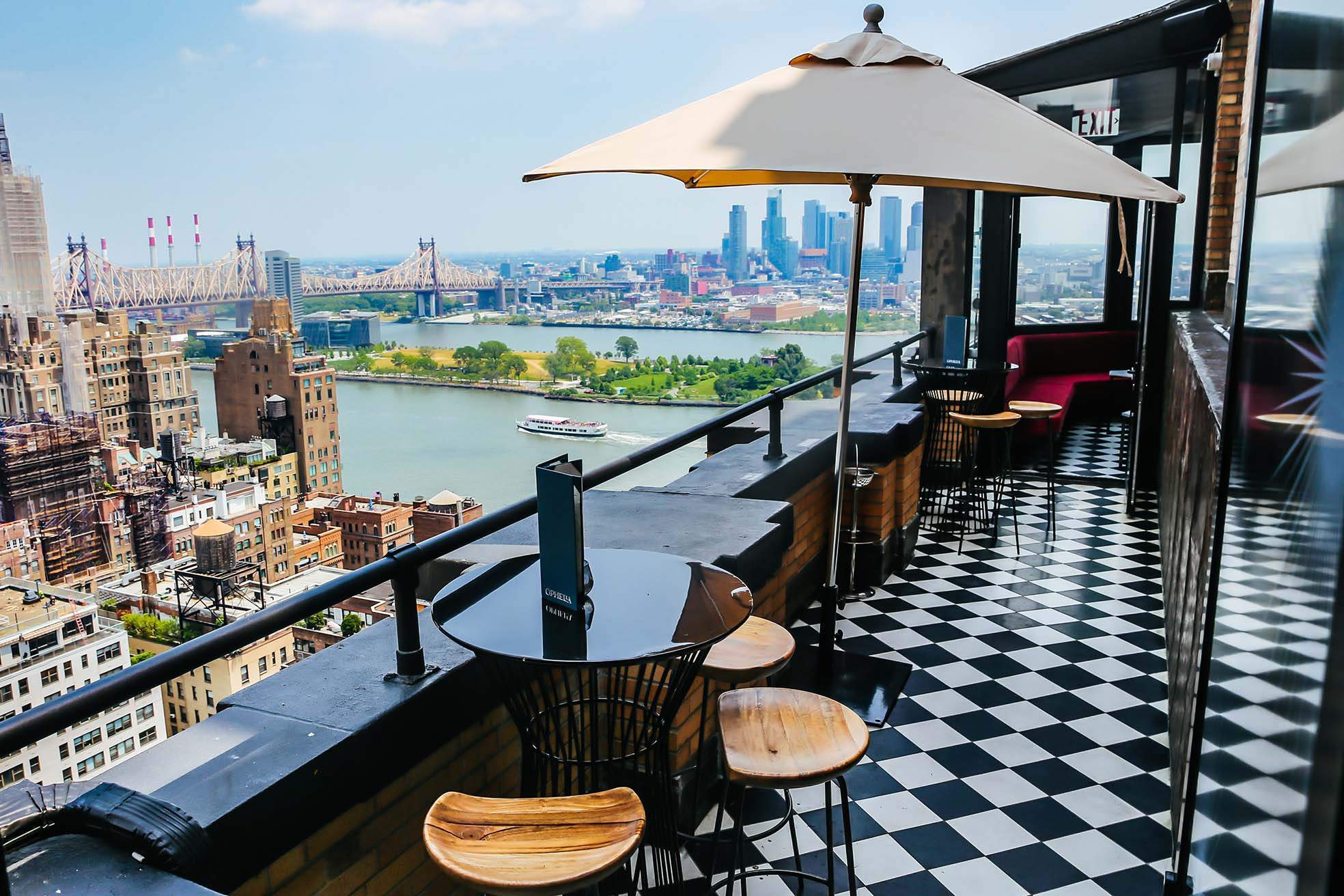 Checkerboard floors and sweeping East River views from the terrace at Ophelia in New York City