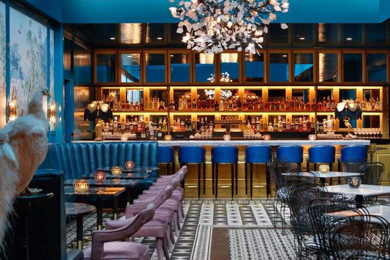 Rolled leather banquettes and rich velvets make up the interiors at Peacock Room at the Hotel Fontenot.