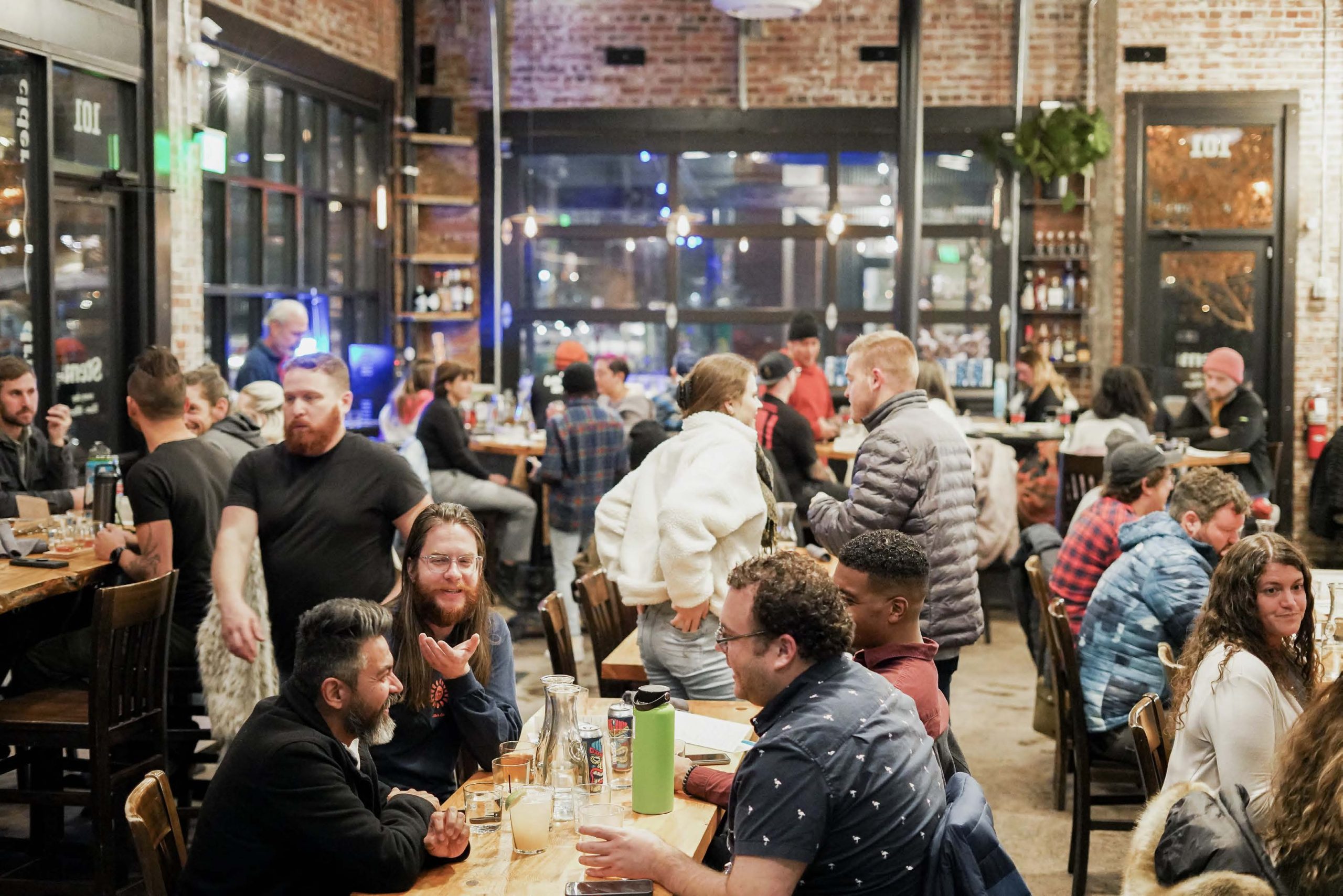 People fill the buzzy indoor seating area at Stem Ciders Taproom in Denver