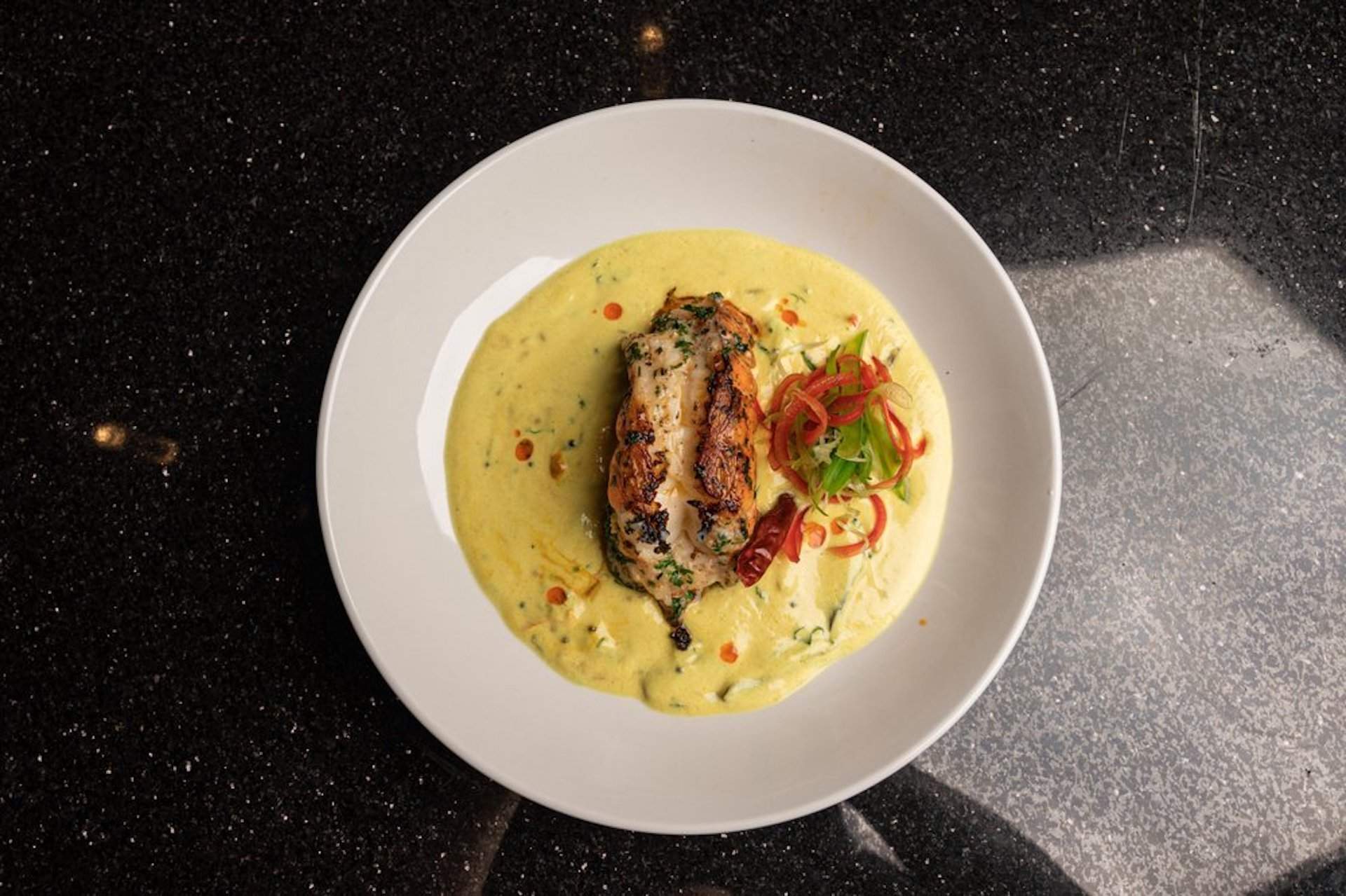 A lobster dish with a yellow sauce at CaliChilli