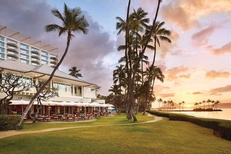 Palm trees flank the terrace at Plumeria Beach House in Honolulu.