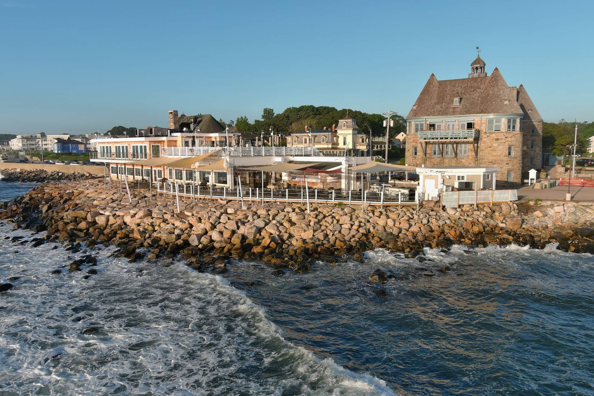 Waves from Narragansett Bay hit the rocks by The Coast Guard House, a restaurant in Rhode Island.