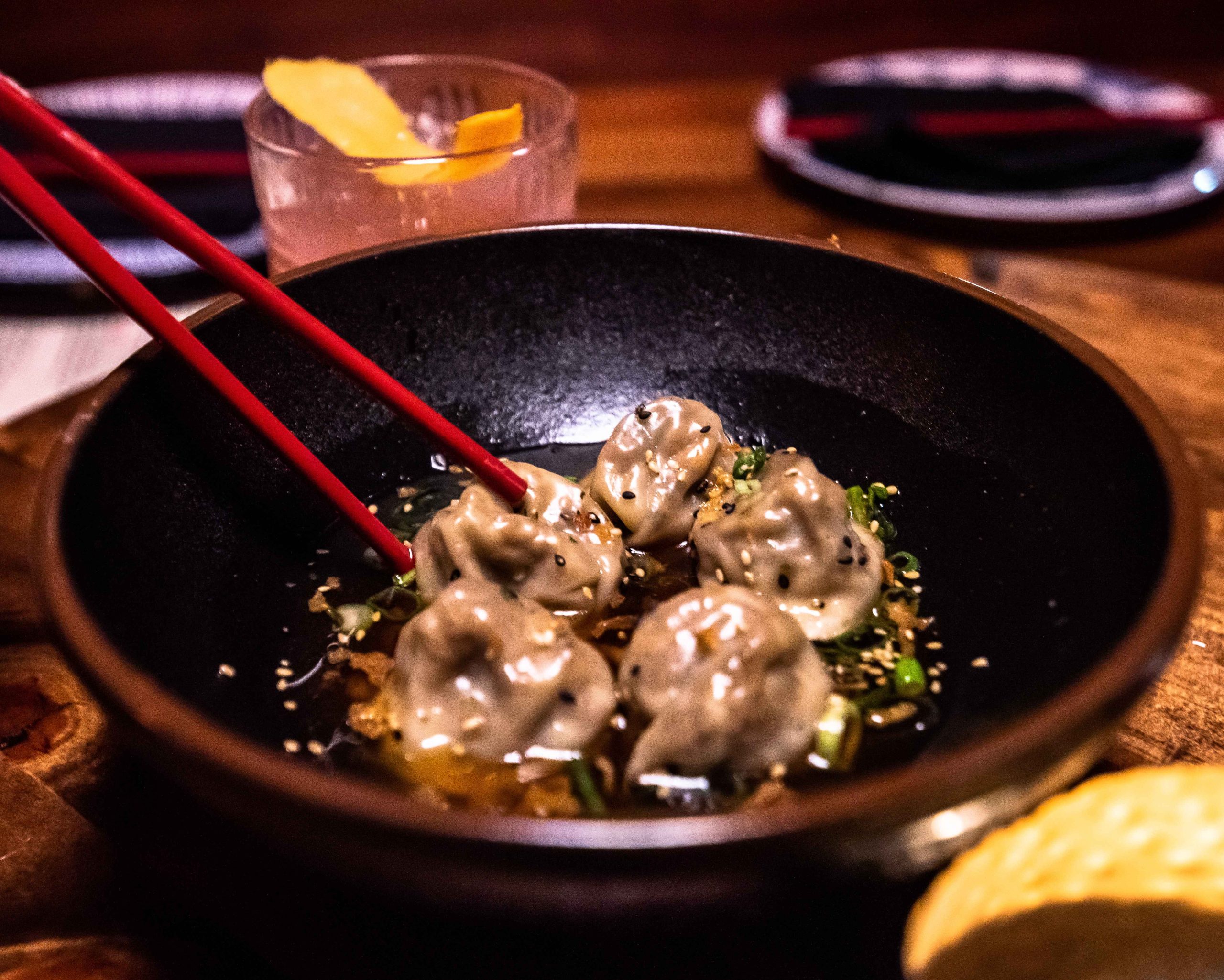 The Everything Mushroom Dumplings with shiitake mushrooms, scallions, daikon sprouts, mushroom dashi, crispy onions, and furikake seasoning at Bao Brewhouse in Denver