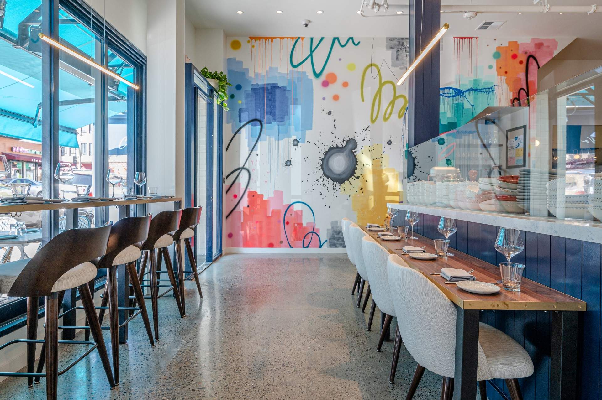 A colorful mural on the white walls at Cassava in North Beach.