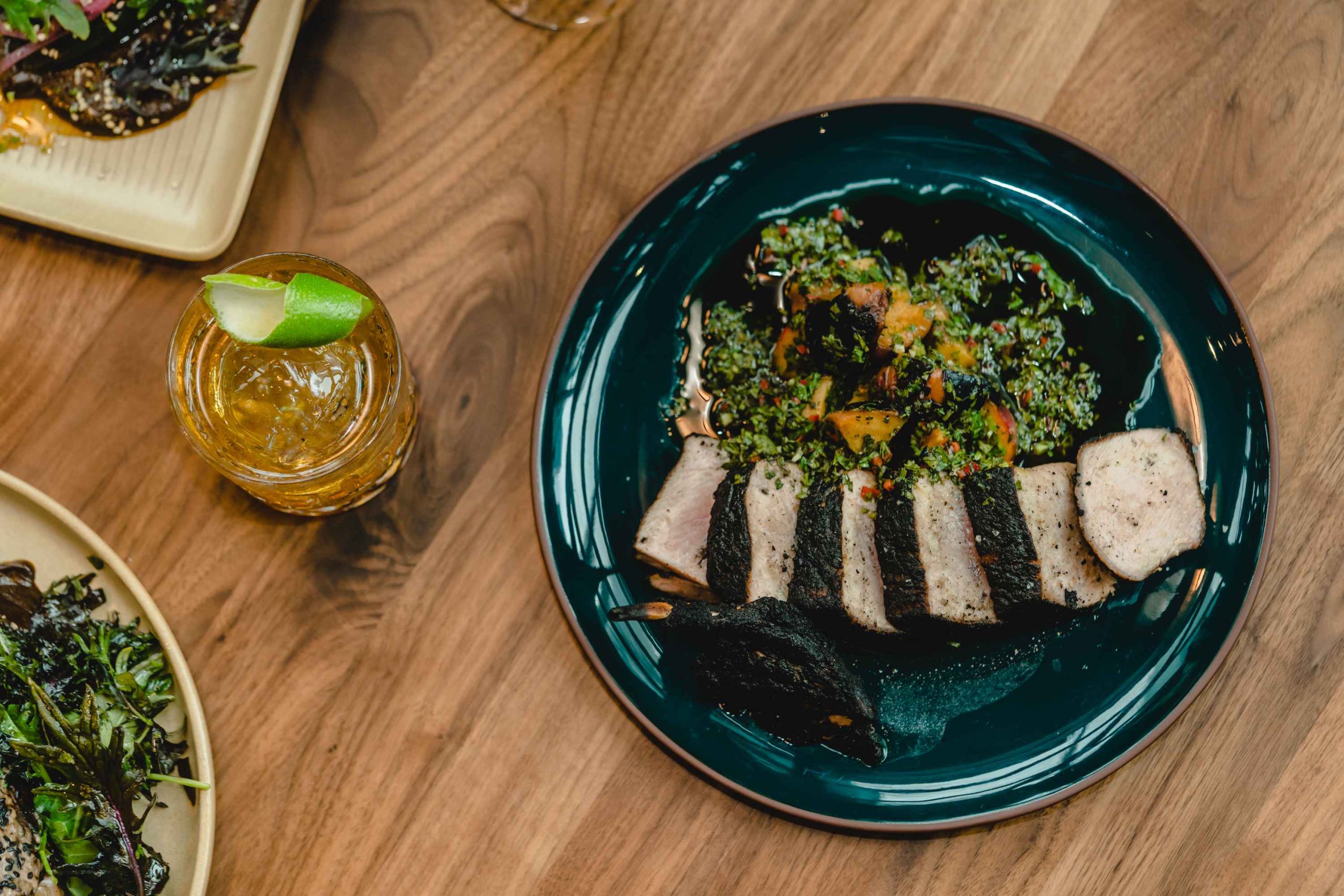 A pork chop with spiced ash, citrus supremes, and mojo at Ember Kitchen in Austin