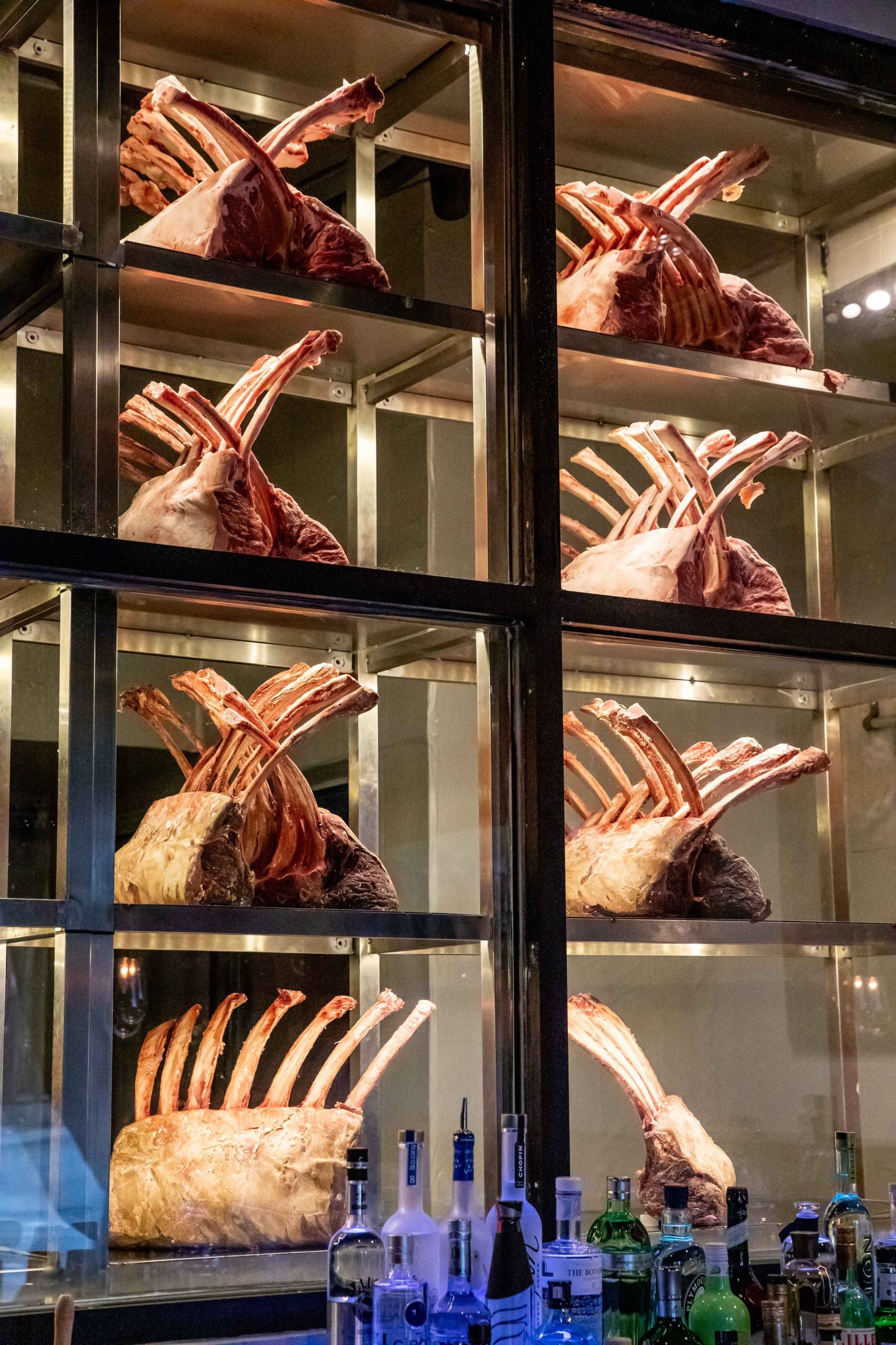 A glass case displaying rib-eye steaks at GAIA Steakhouse in New Orleans