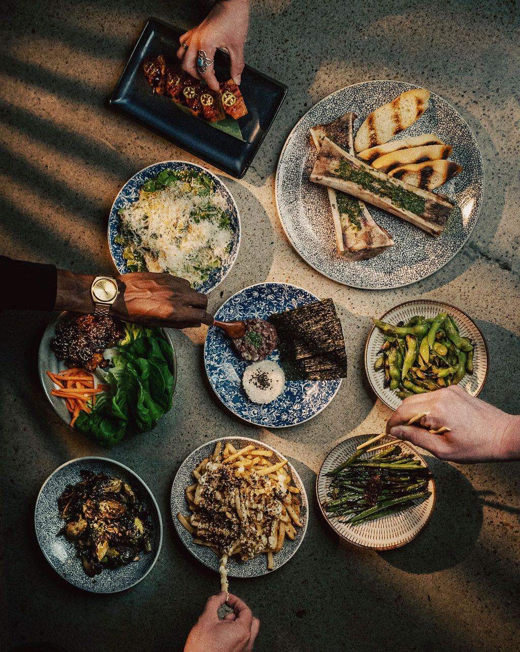 A wood-fired spread at Noko in Nashville includes bone marrow, edamame, and fries with furikake and truffle aioli