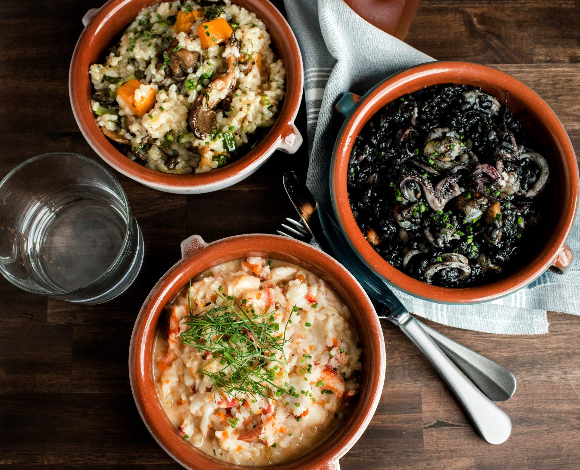 Mushroom paella, squid ink risotto, and lobster risotto at Pescador in Fenway