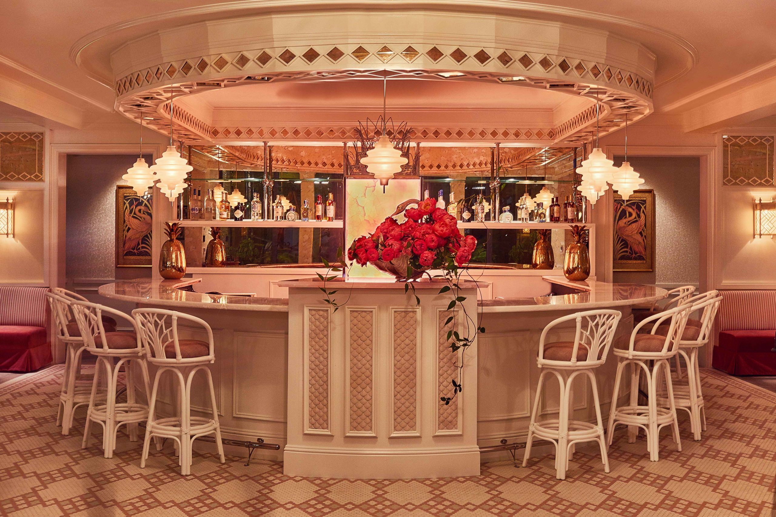 A horseshoe-shaped bar is topped with an extra-large floral arrangement at Swan in Miami.
