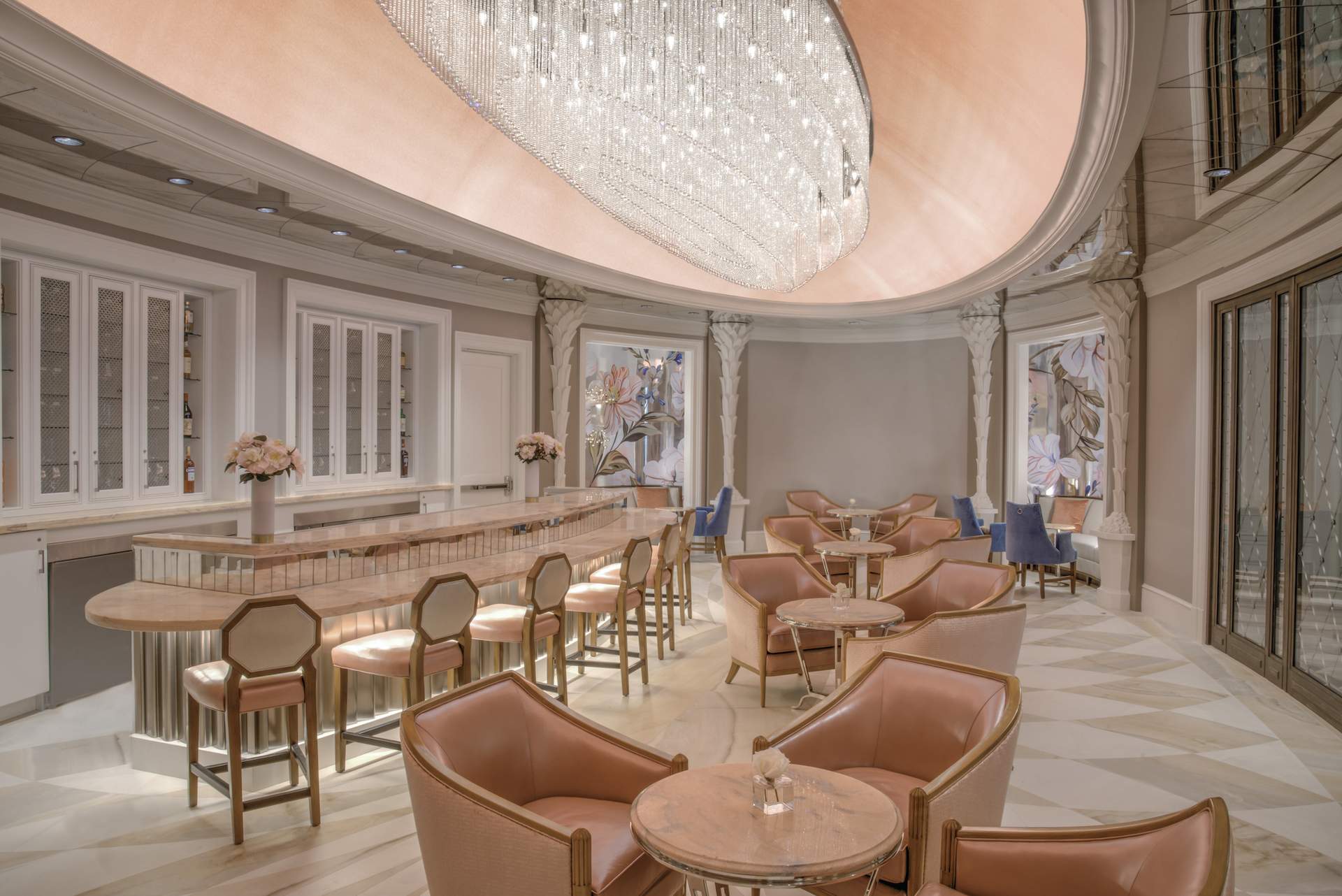 The bold pink interiors at Camellias in Charleston include a glowing marble bar.